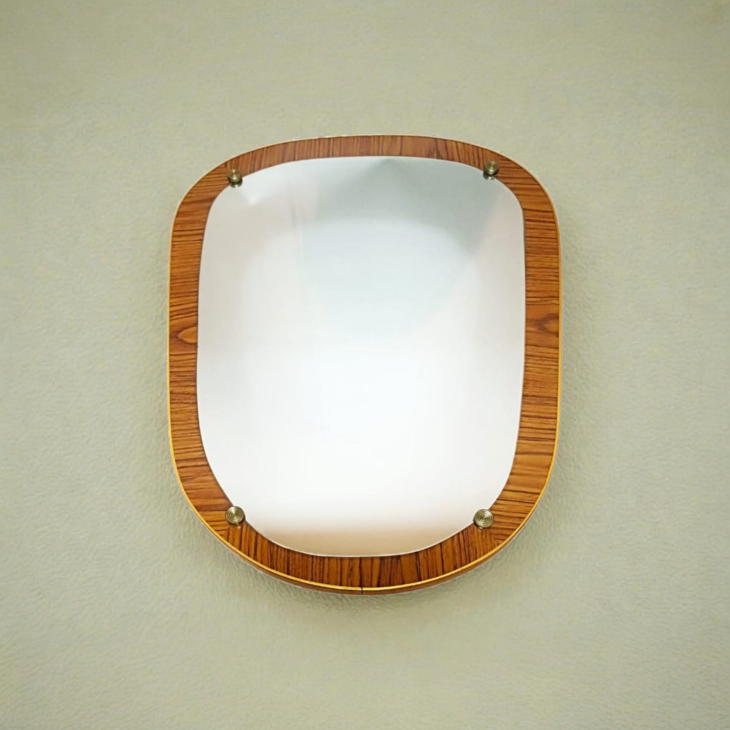 Vintage organic wall mirror displayed hanging on a wall