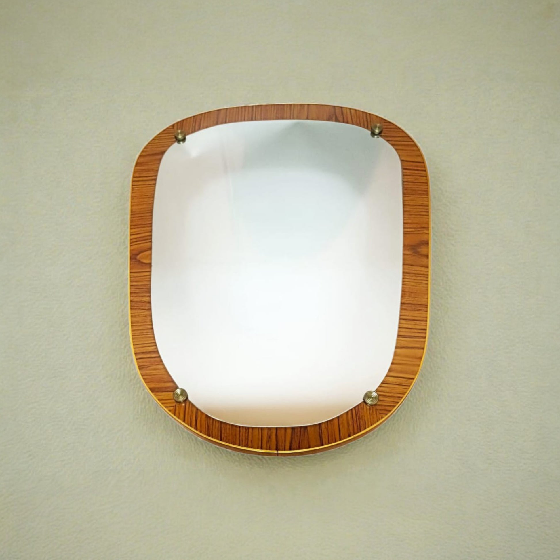 Vintage organic wall mirror displayed hanging on a wall