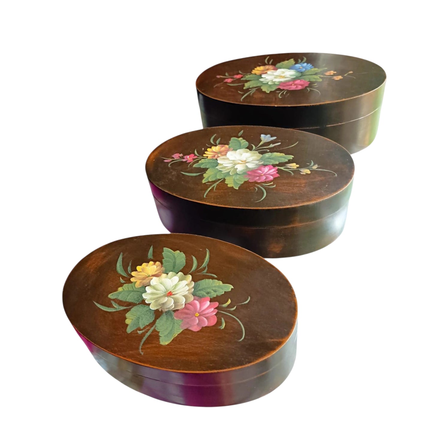 Vintage graduated set of three oval floral wooden boxes.