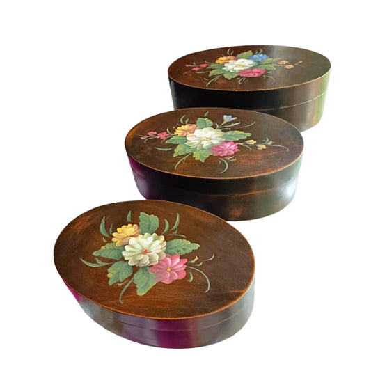 Vintage graduated set of three oval floral wooden boxes.