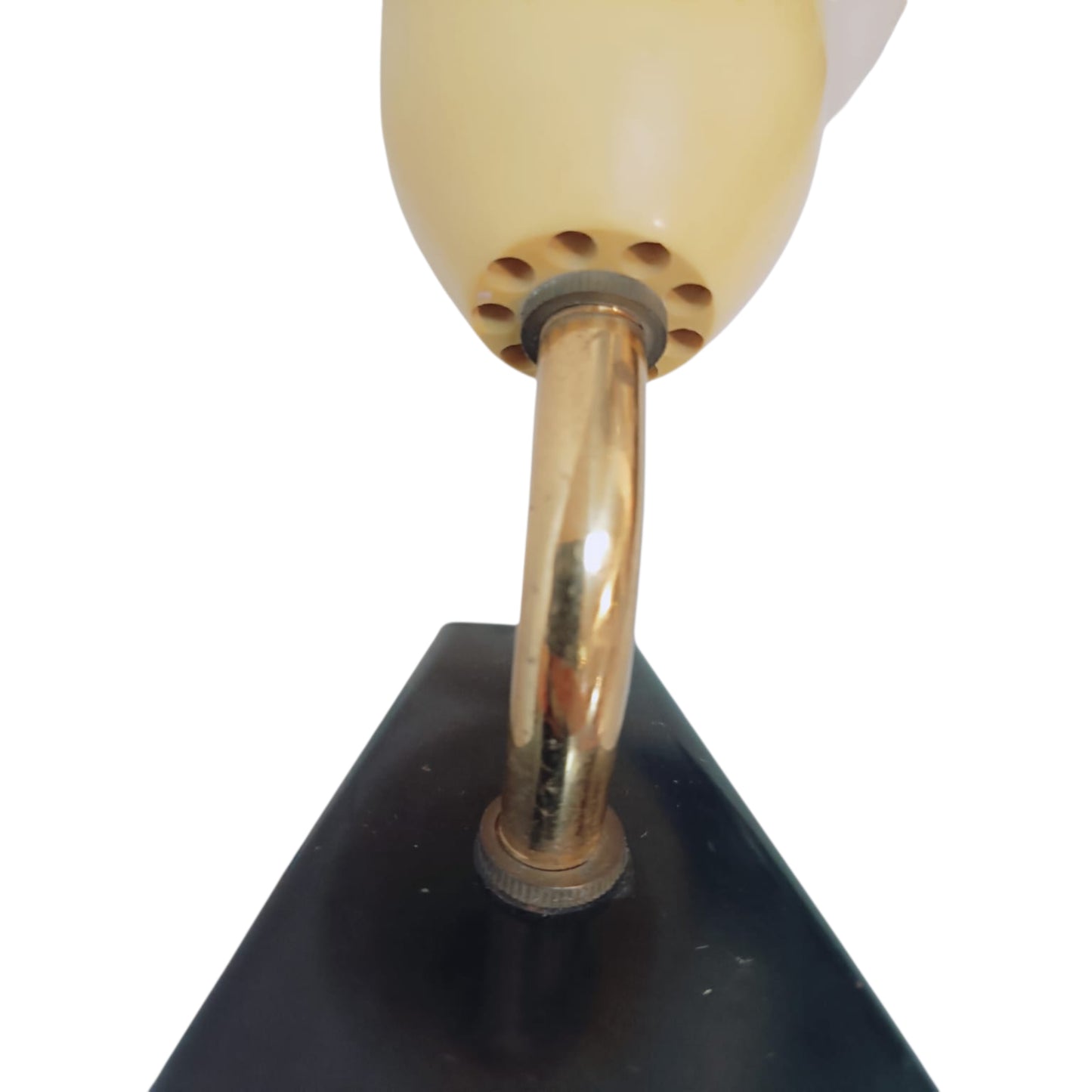Close view of the curved brass-tone arm and black mounting plate of the vintage wall light