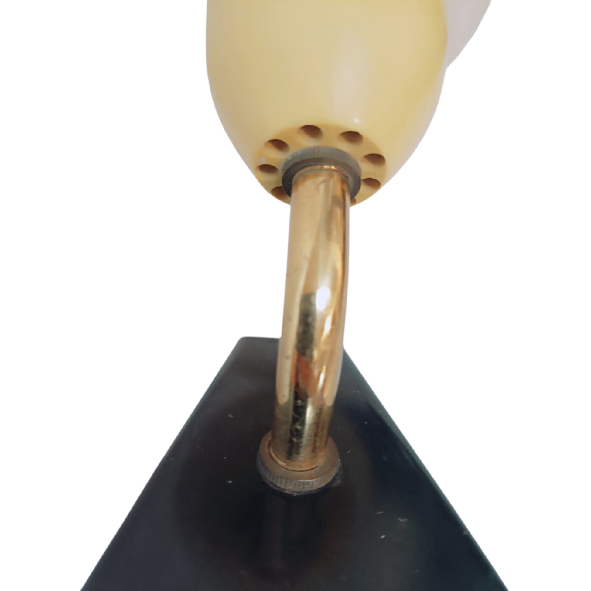 Close view of the curved brass-tone arm and black mounting plate of the vintage wall light