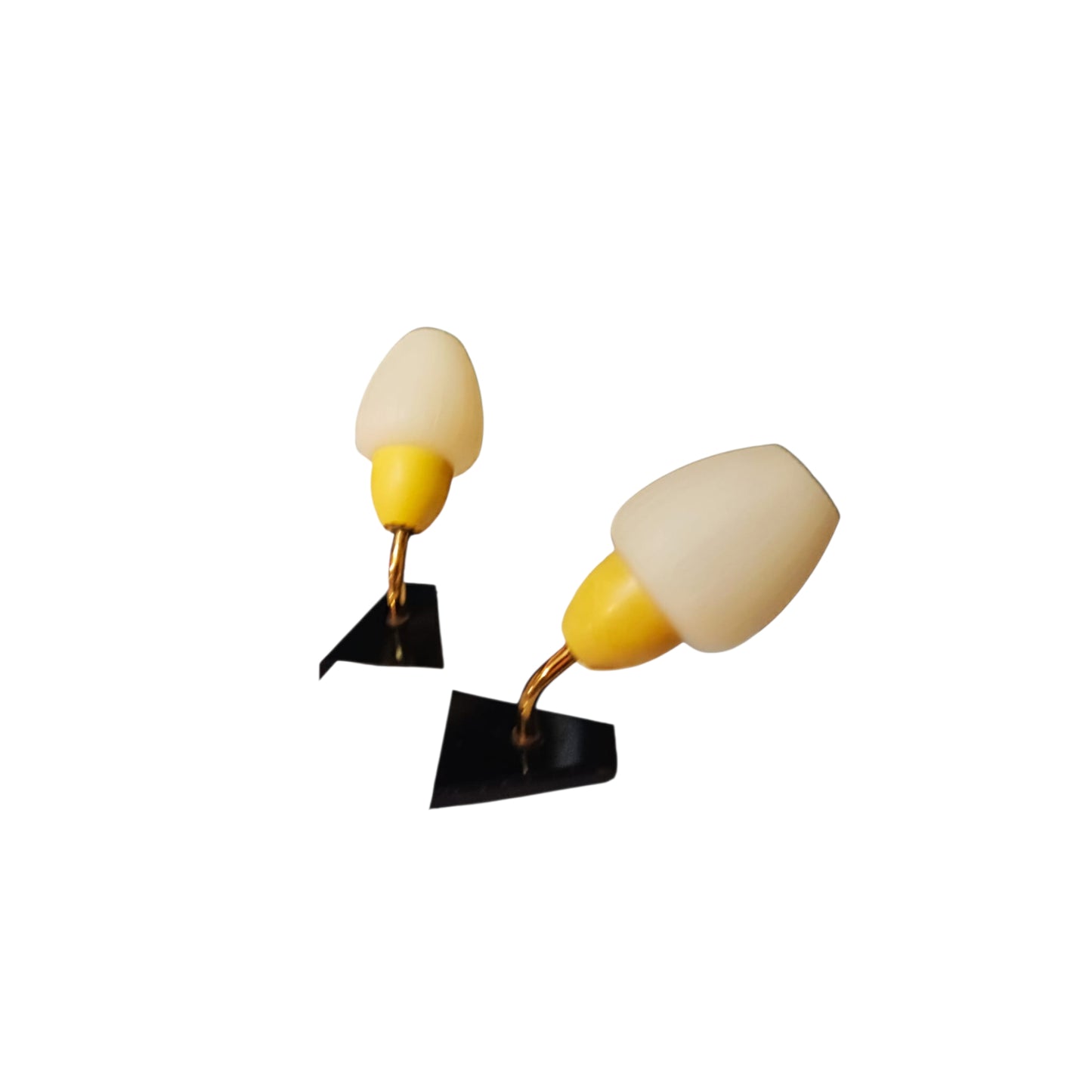 Pair of vintage yellow, white and black wall lights viewed from an angle