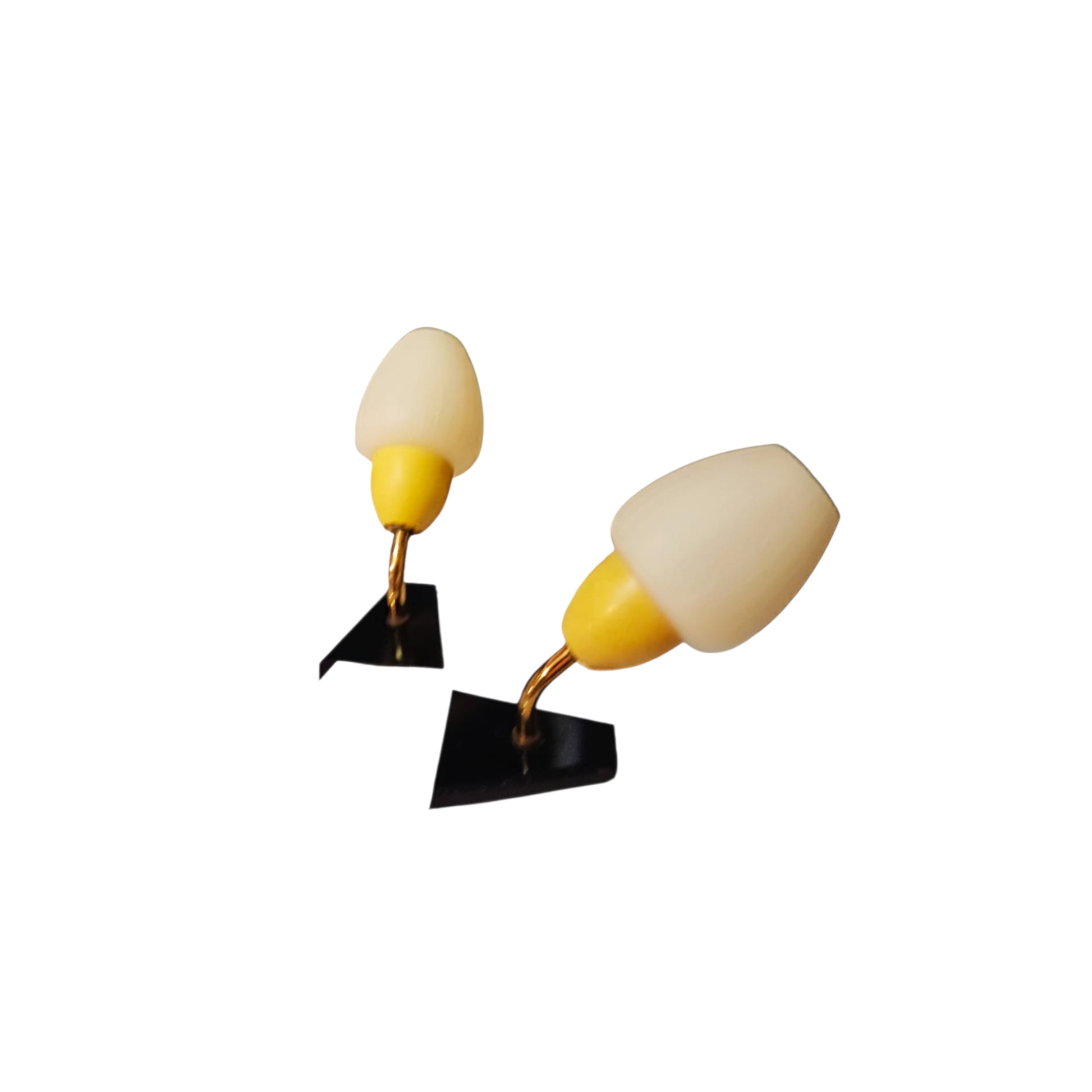Pair of vintage yellow, white and black wall lights viewed from an angle