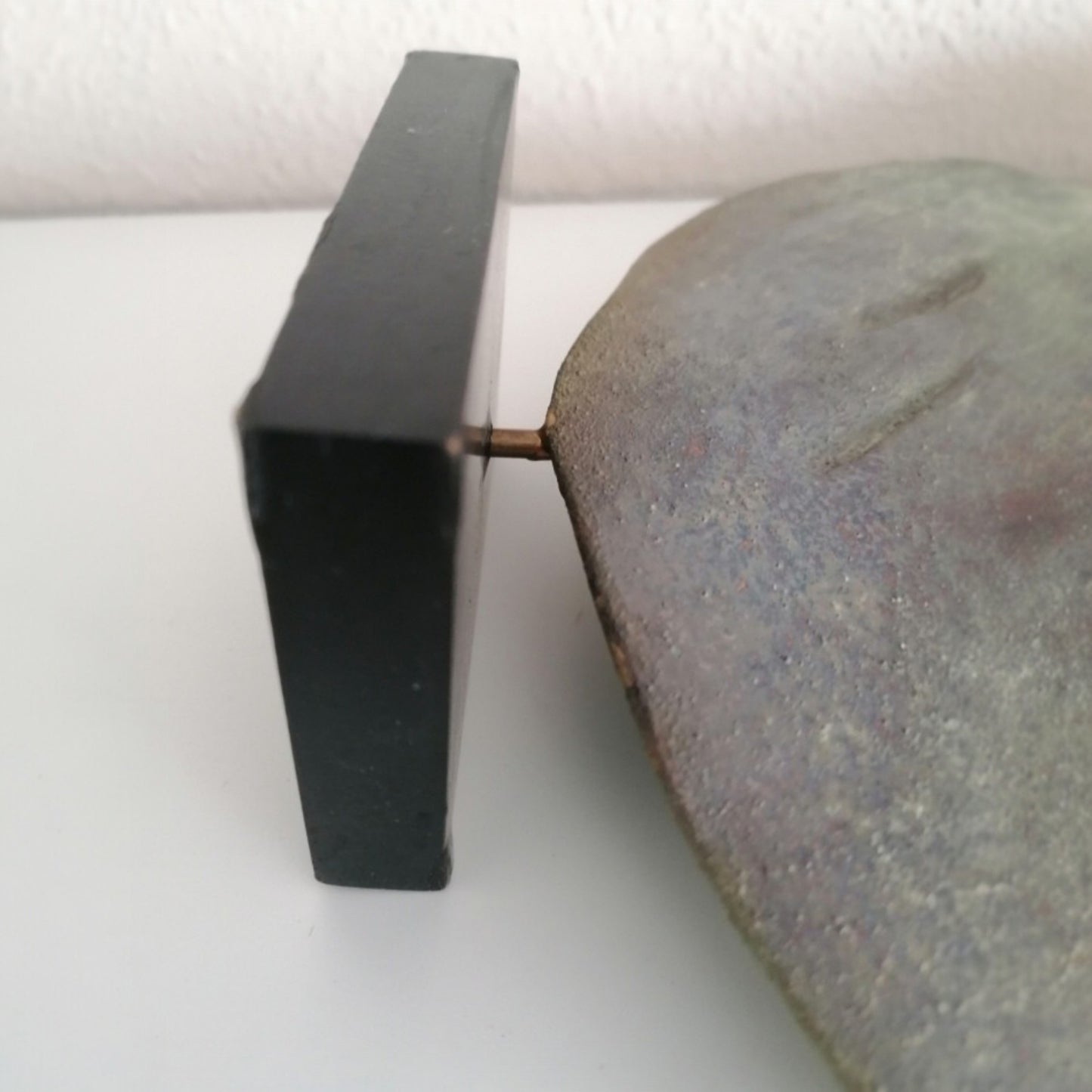 Black wooden base and metal support of the ceramic dove sculpture 