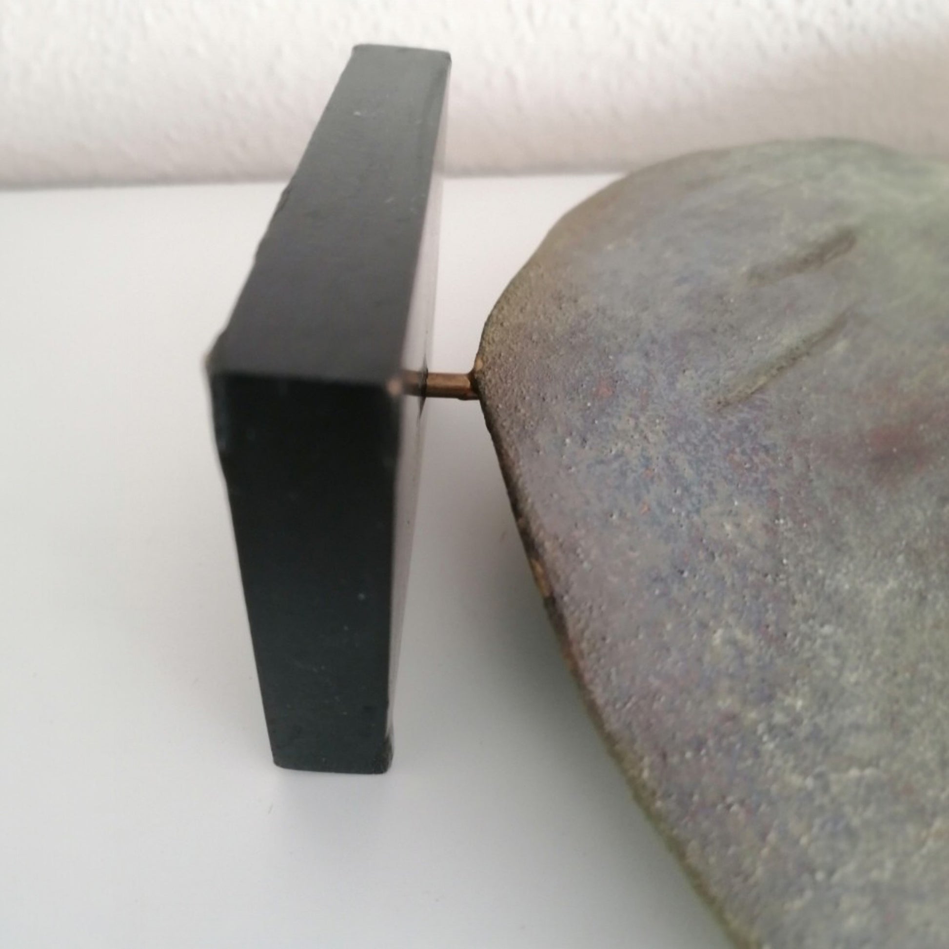 Black wooden base and metal support of the ceramic dove sculpture 