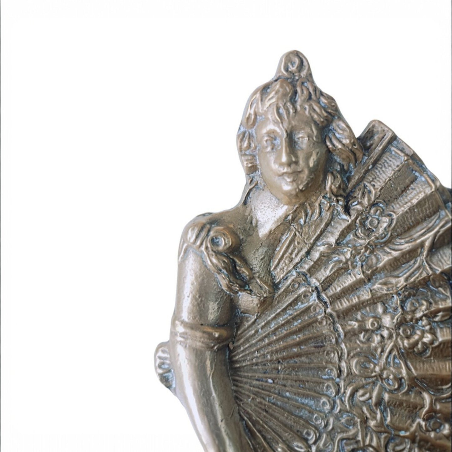 Three-quarter view of the cast-metal female figure and ornamental fan dish 
