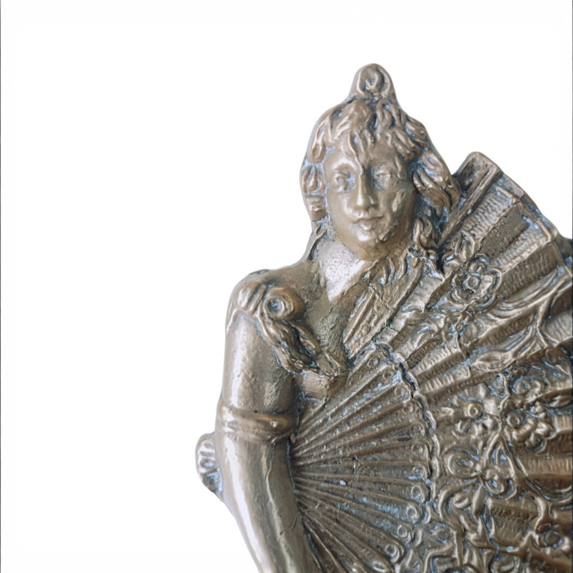 Three-quarter view of the cast-metal female figure and ornamental fan dish 