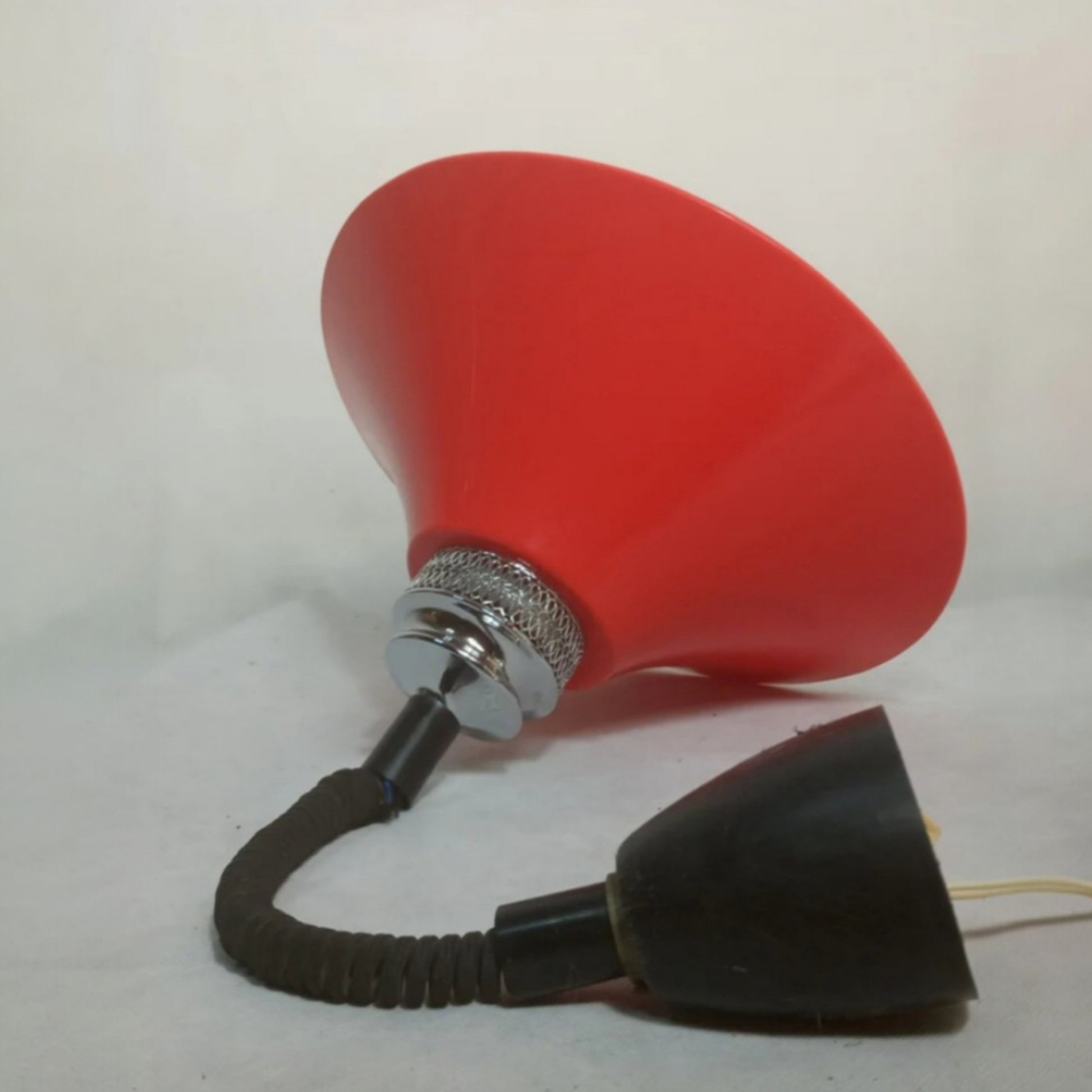 Side view showing the flexible suspension and red moulded plastic shade