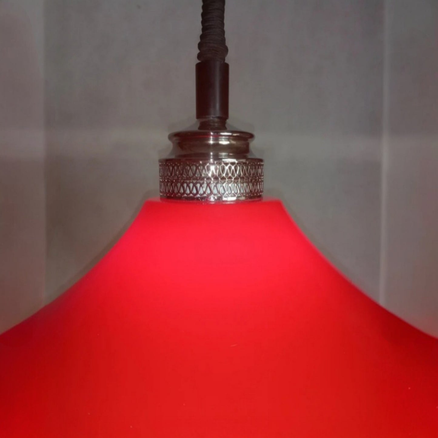 Close view of the chrome-plated fitting above the red plastic shade