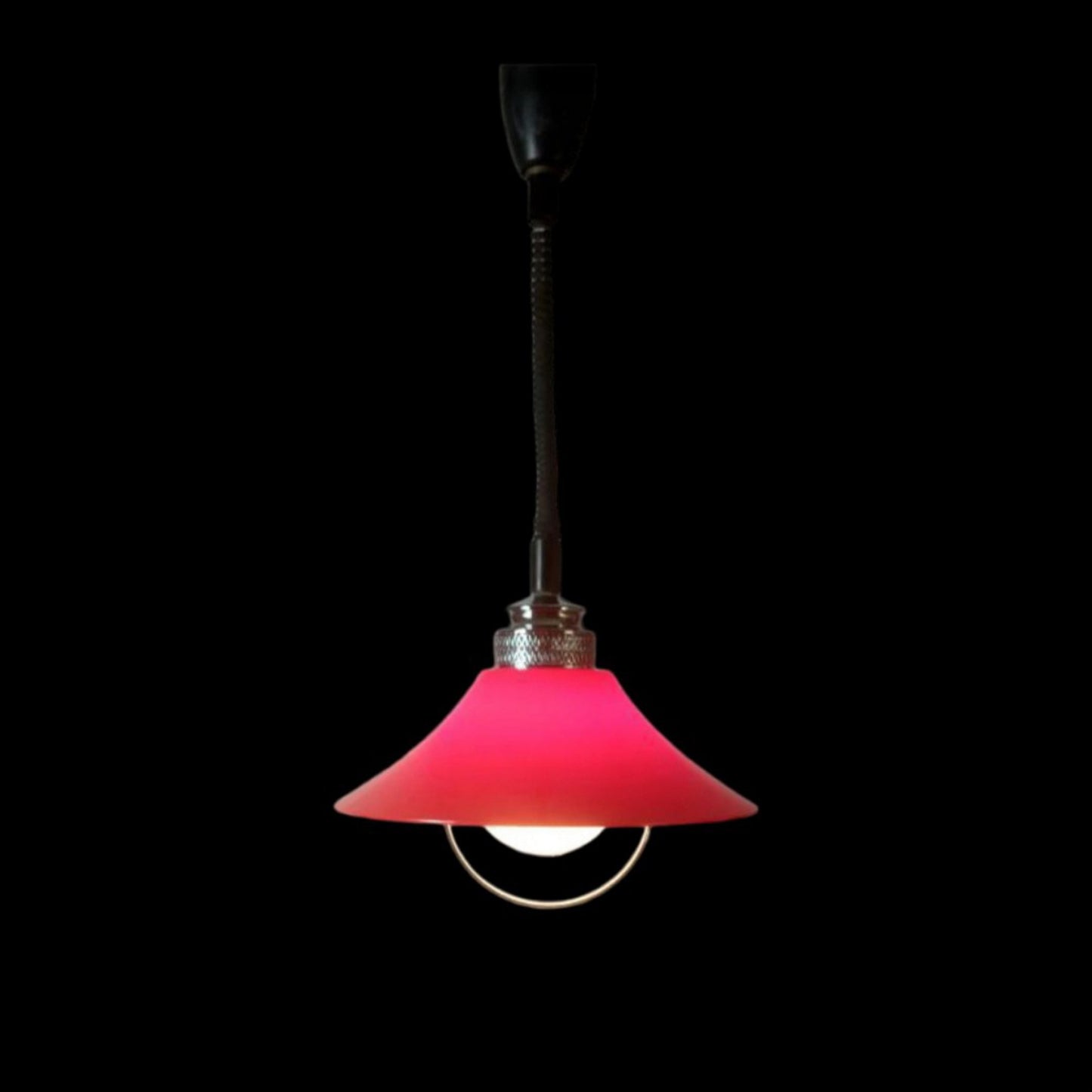 Red Space Age pendant lamp illuminated against a dark background