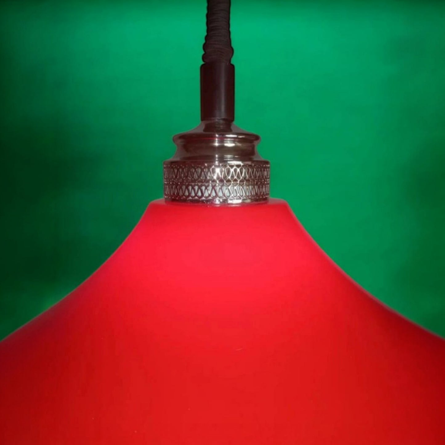 Close view of the chrome-plated fitting above the red plastic shade