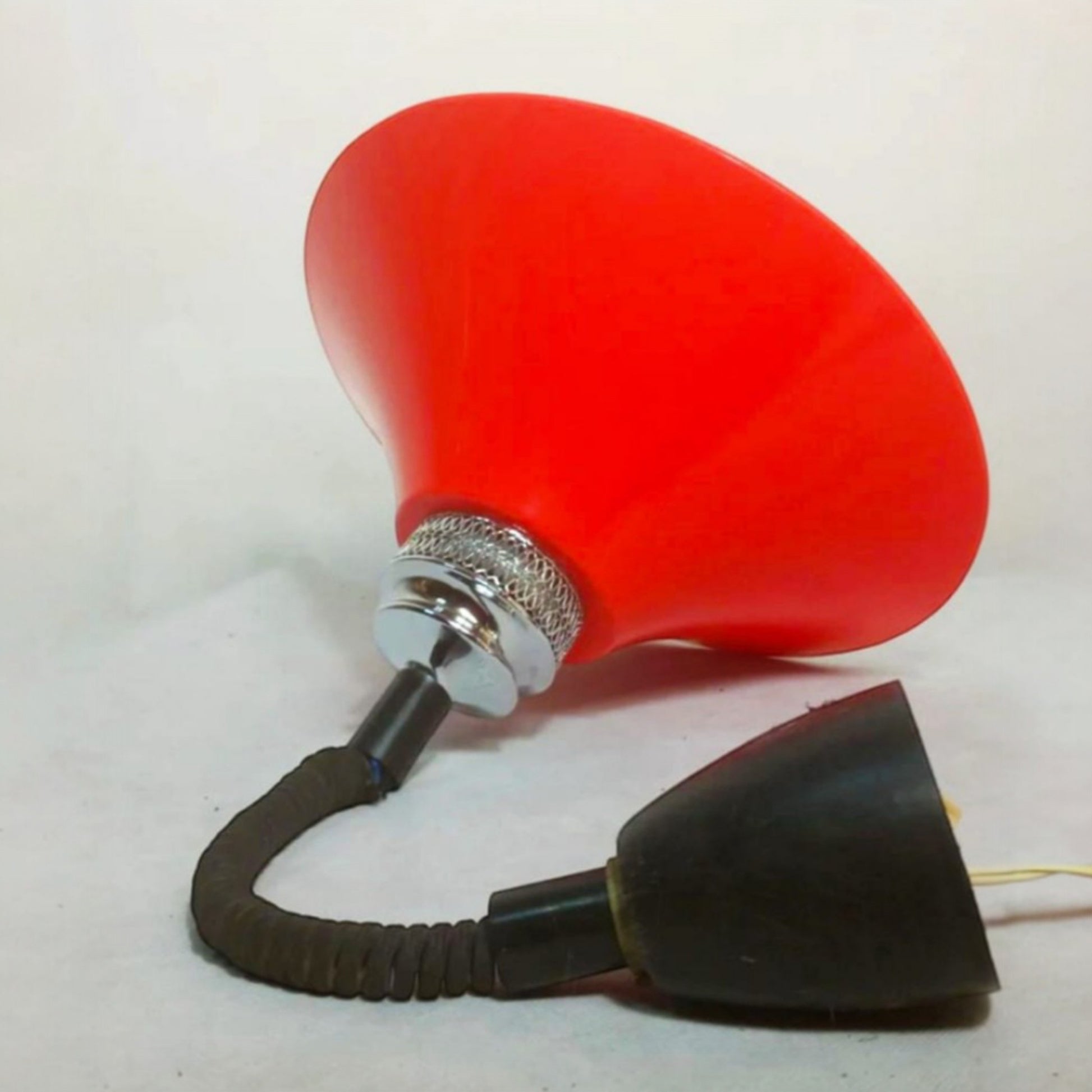 Side view showing the flexible suspension and red moulded plastic shade