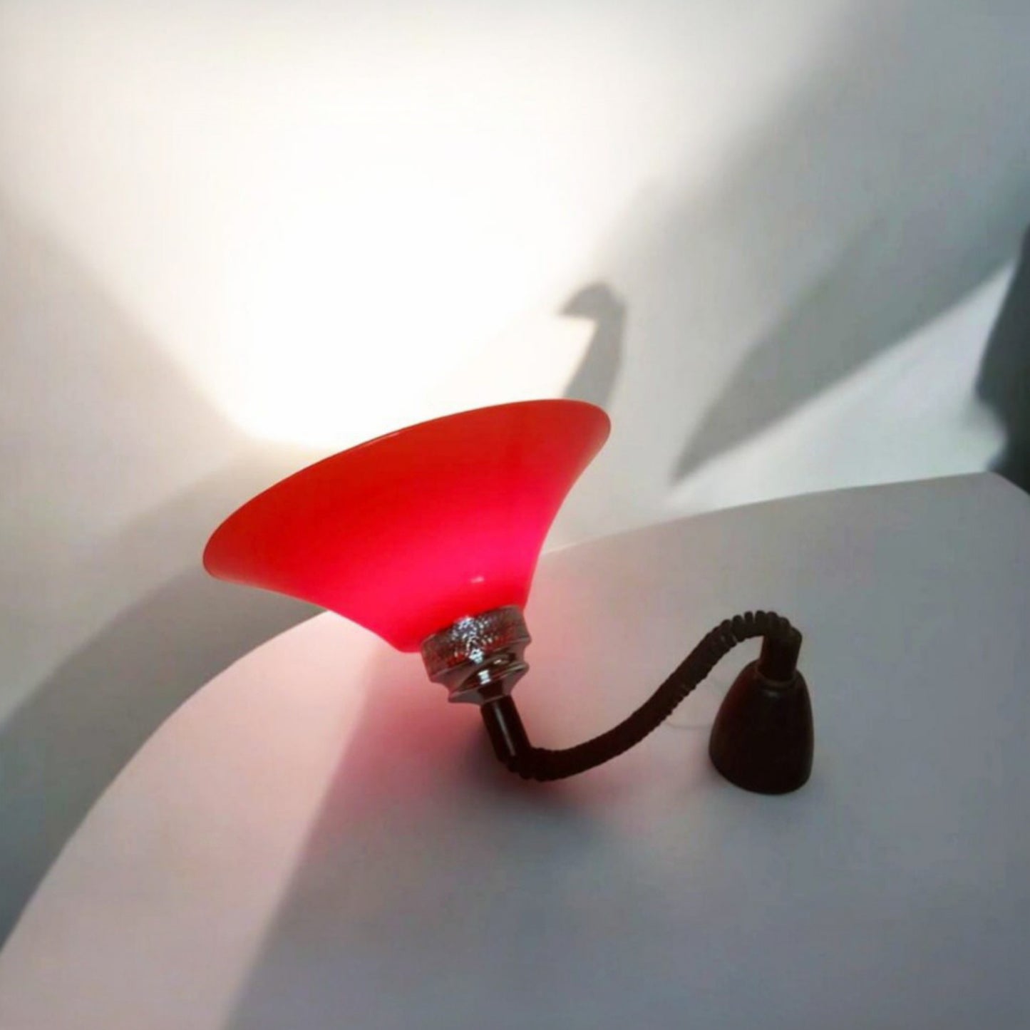 Side view of the pendant lamp resting on its shade