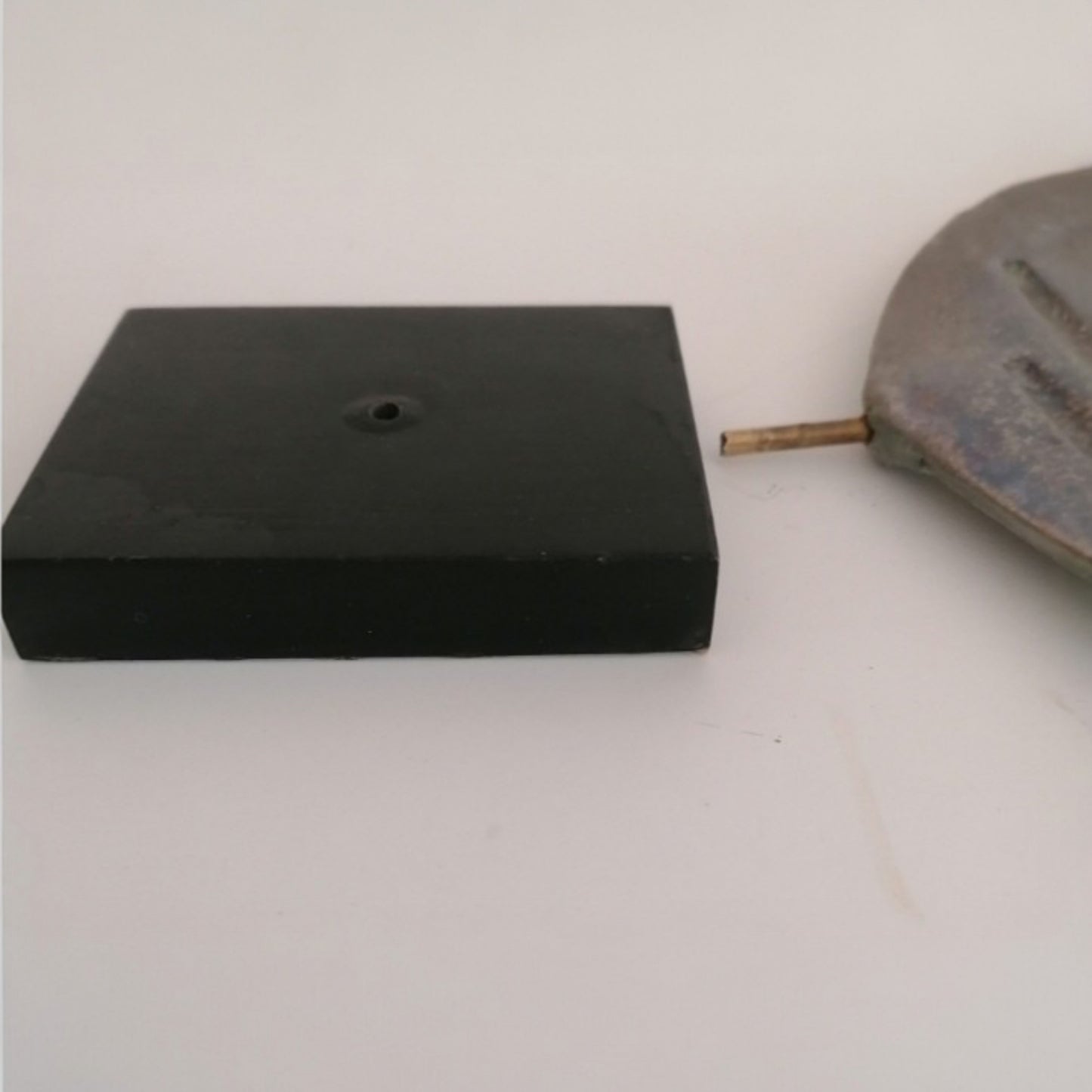 Black wooden base and metal support of the ceramic dove 