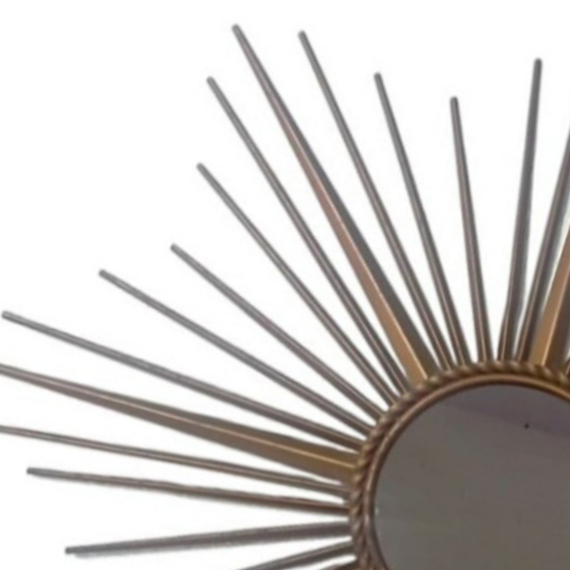 Close-up of the slender metal rays surrounding the circular mirror.