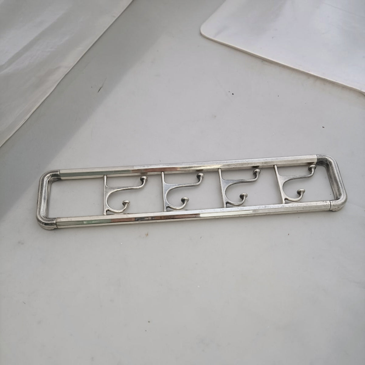 Front view of the long wall coat rack with its hooks aligned.