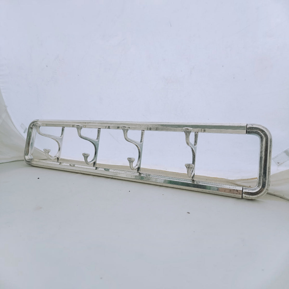 Side view of the rectangular brass frame and curved double hooks