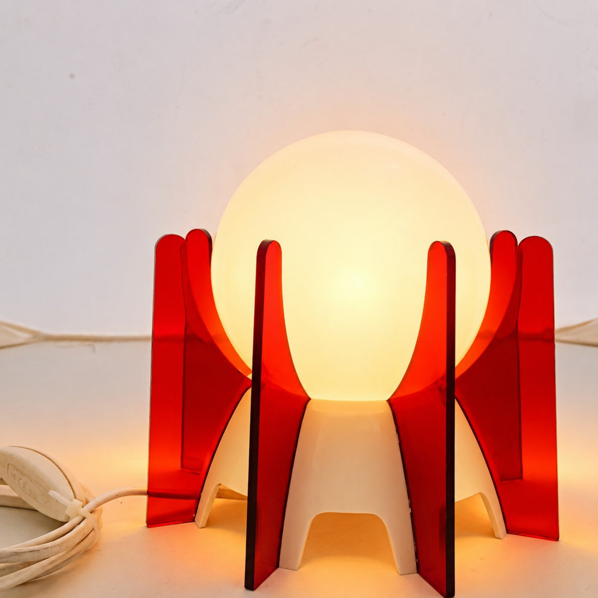 Illuminated red acrylic and white opaline glass IXO table lamp.
