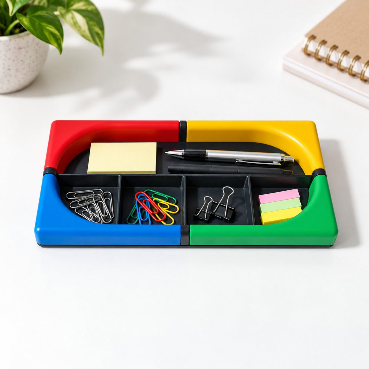Tino desk organiser holding sticky notes, pens, paper clips and binder clips on a white desk