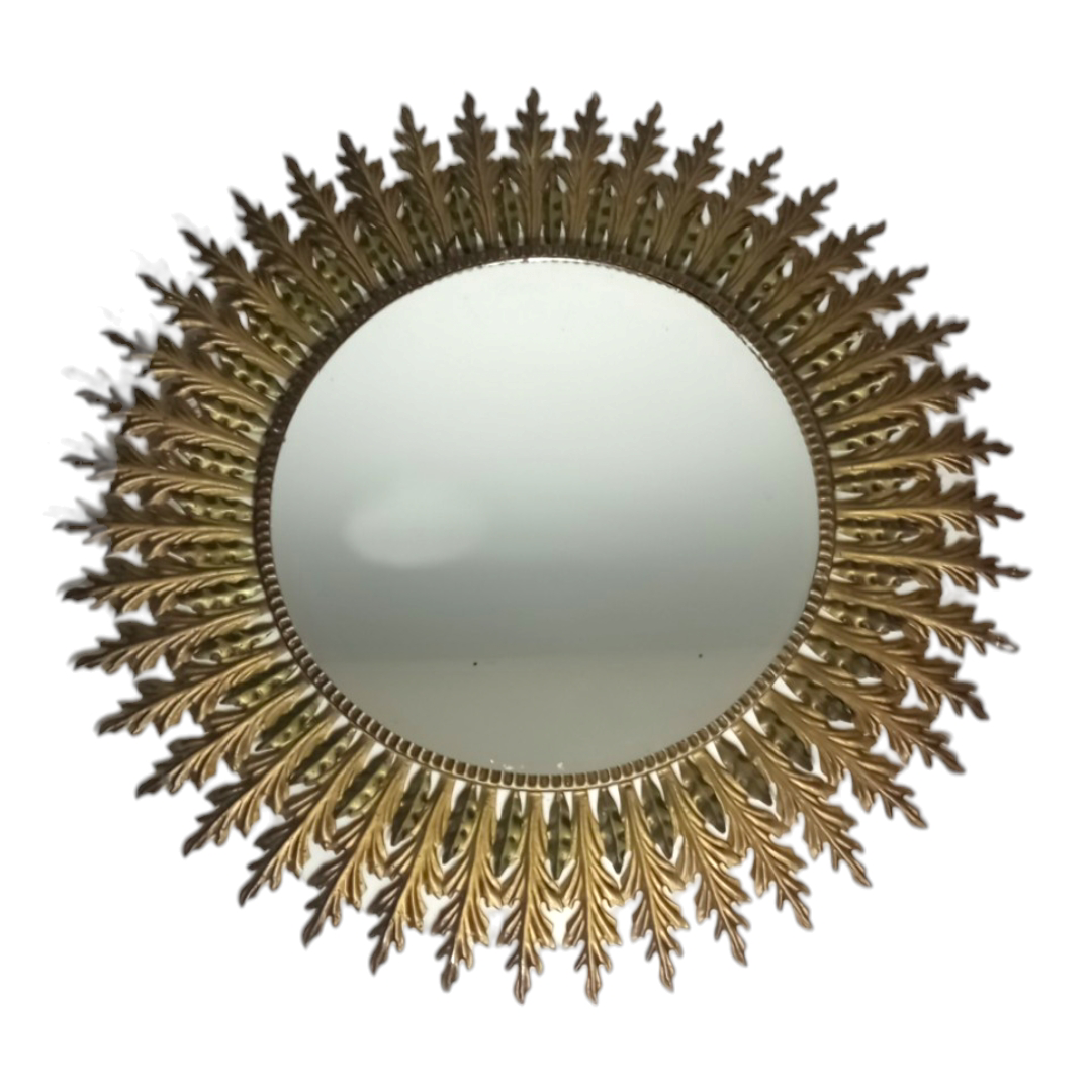 Gold-toned sunburst mirror with leaf rays 