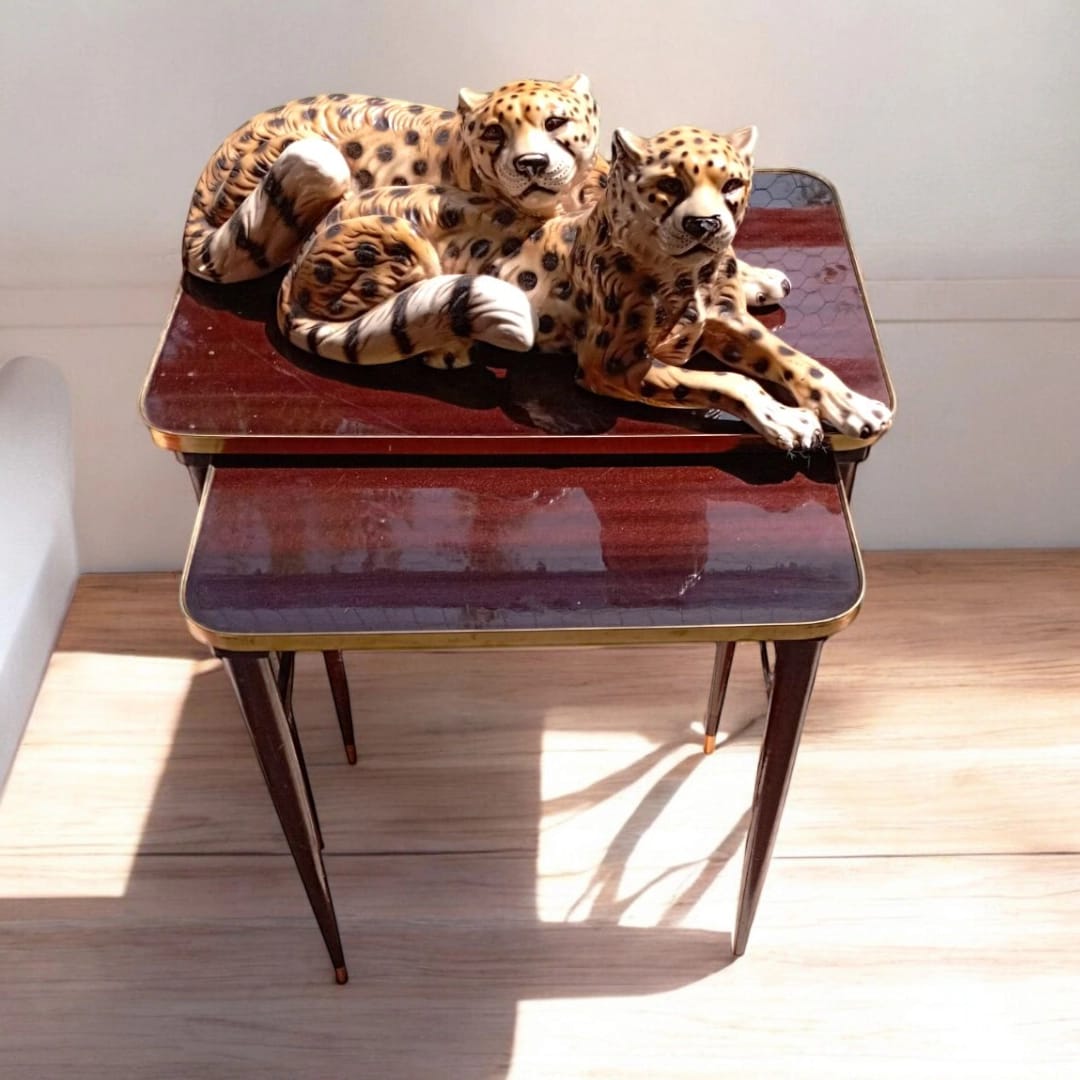Pair of vintage nesting tables with decorative objects
