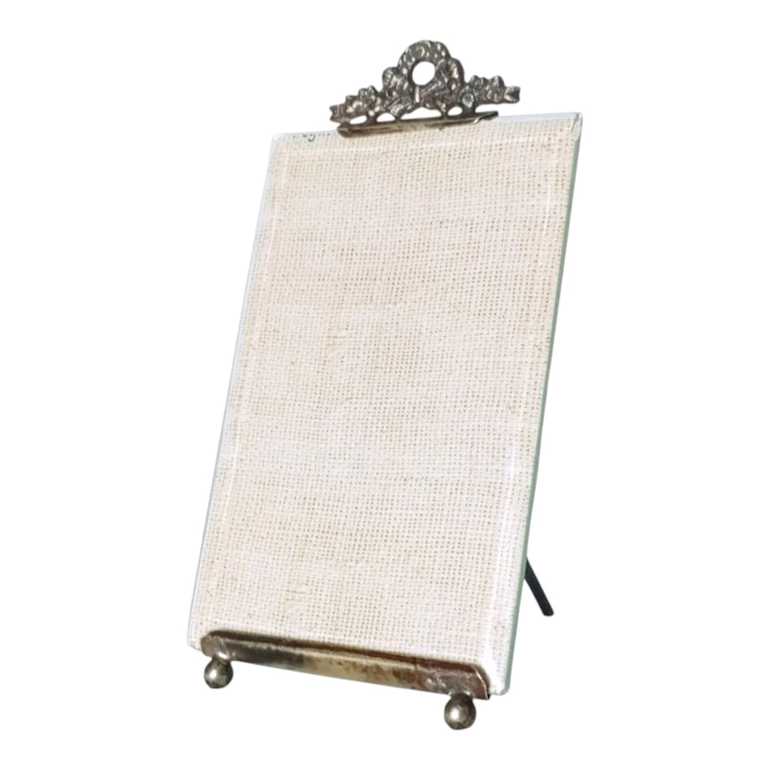 Side view of early 20th century glass photo frame with metal stand