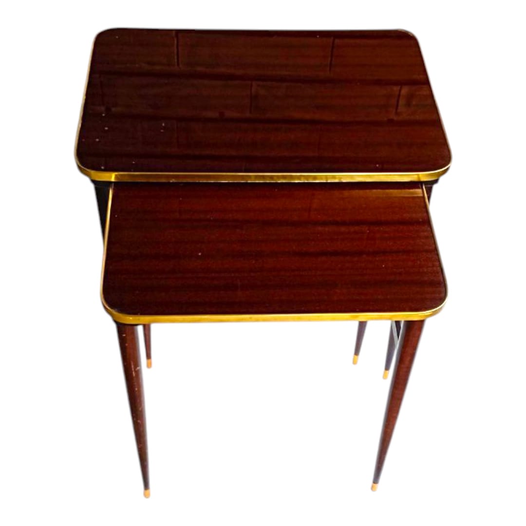 Pair of vintage nesting tables with brass trim