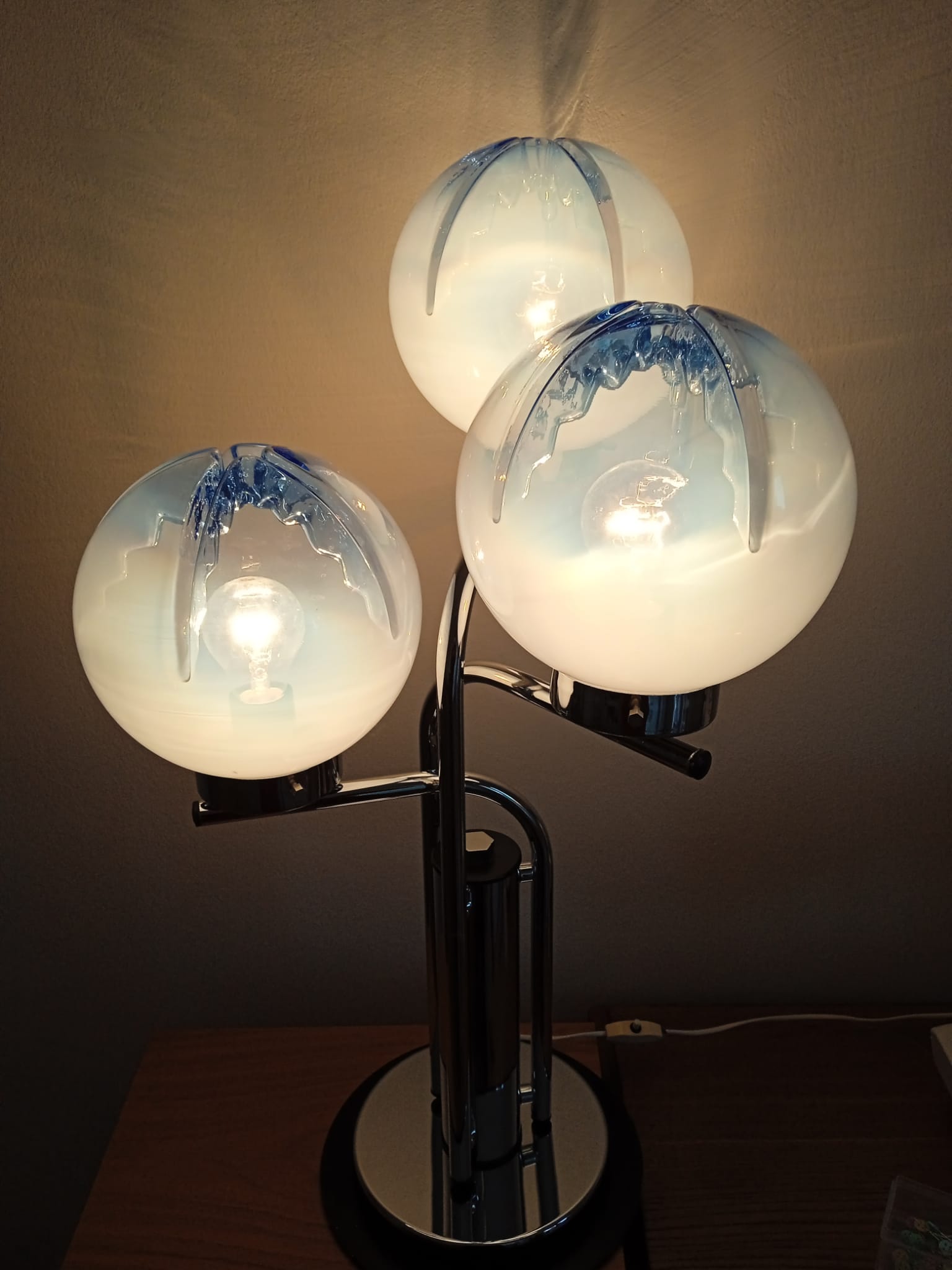 Table lamp attributed to Toni Zuccheri shown lit, warm ambient light