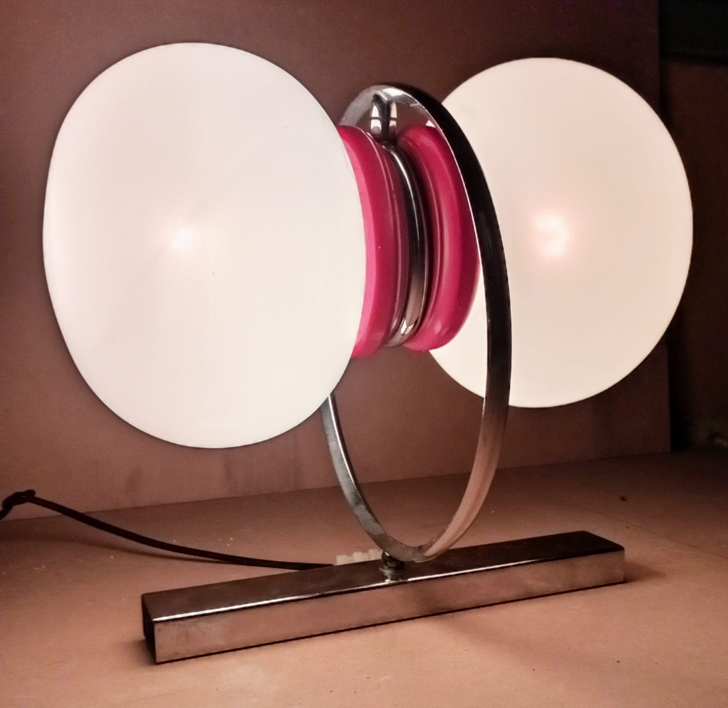 Space Age wall sconce shown illuminated