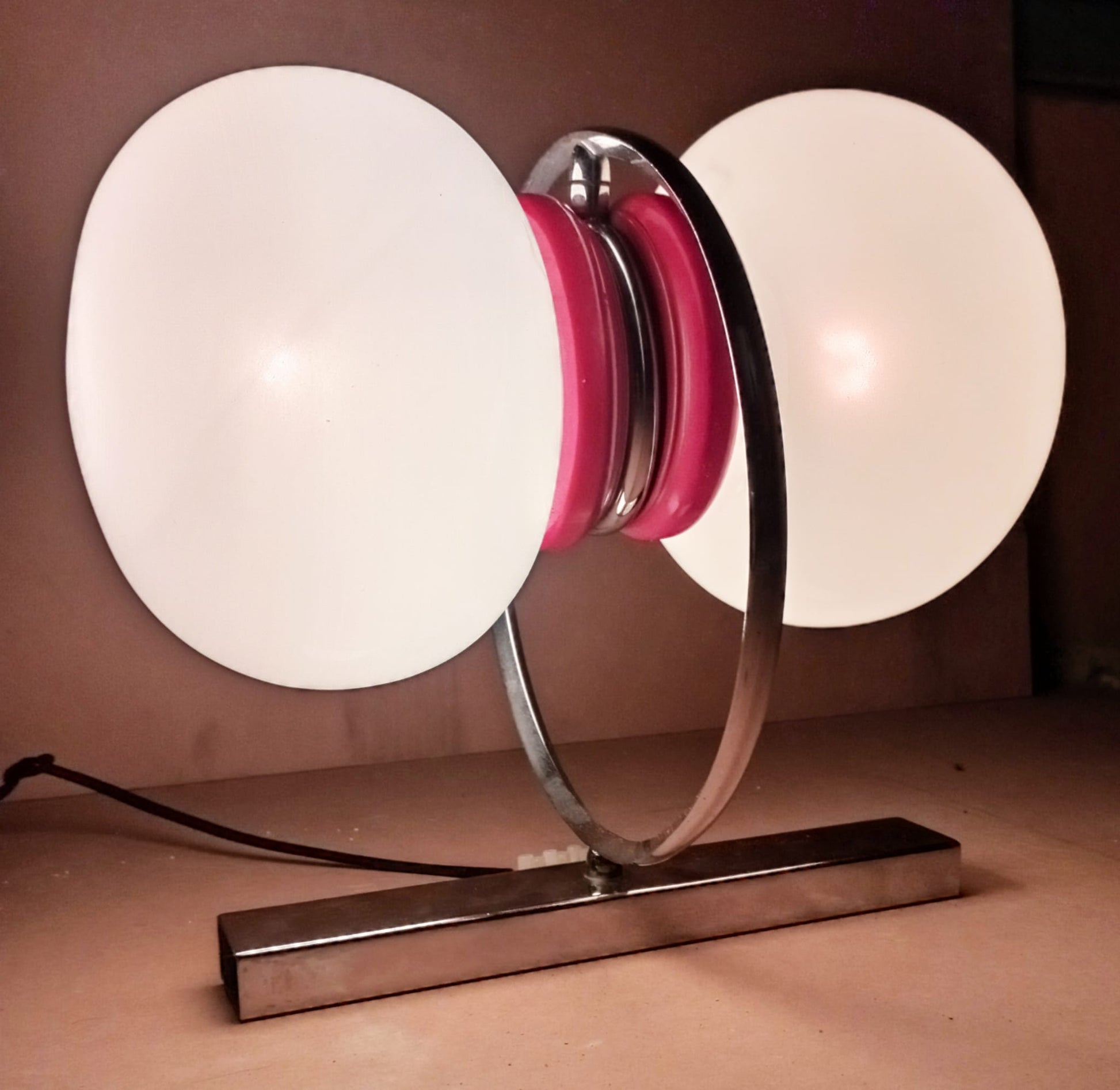 Space Age wall sconce shown illuminated