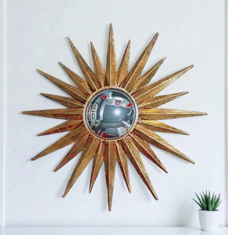 Gold-toned convex sunburst mirror with triangular rays