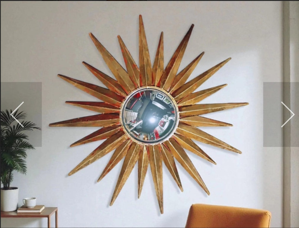 Gold-toned convex sunburst mirror with triangular rays