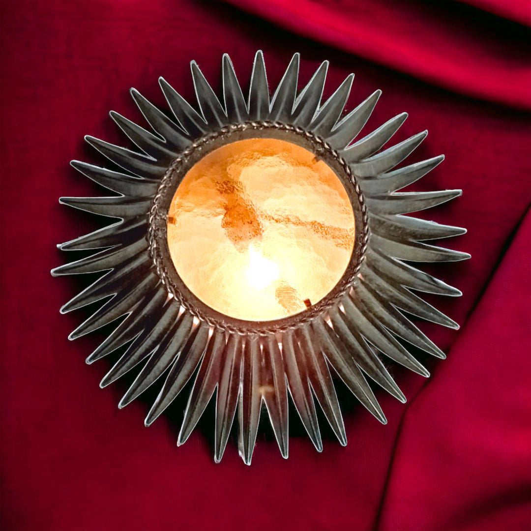 Sunburst lamp lit, golden glass centre casting warm light