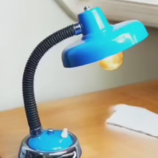 Vintage blue Space Age desk lamp switched on