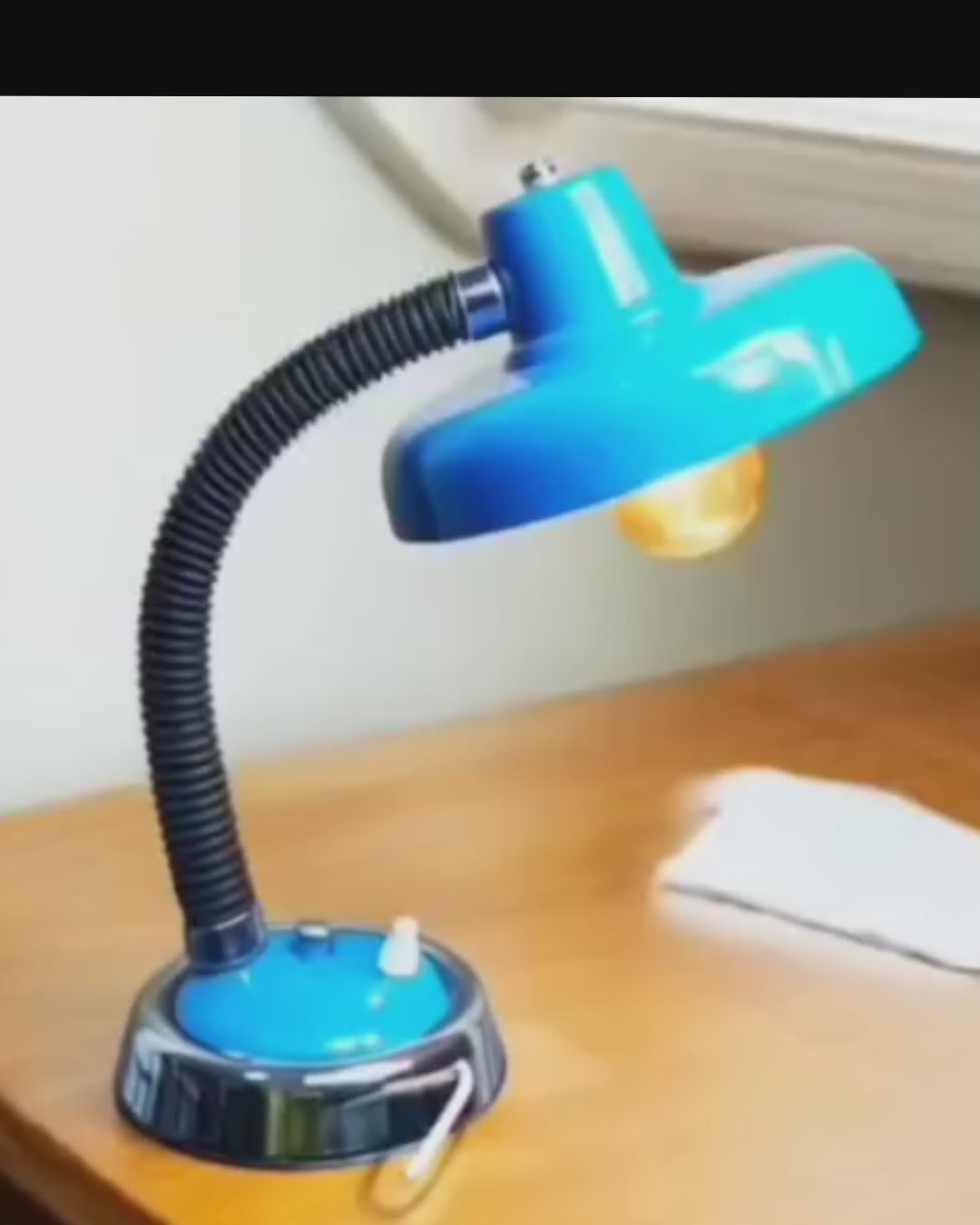 Vintage blue Space Age desk lamp switched on