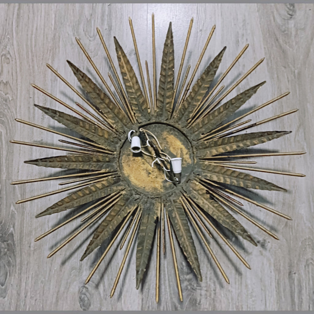 Reverse of the wall light showing its radial metal construction and electrical fittings