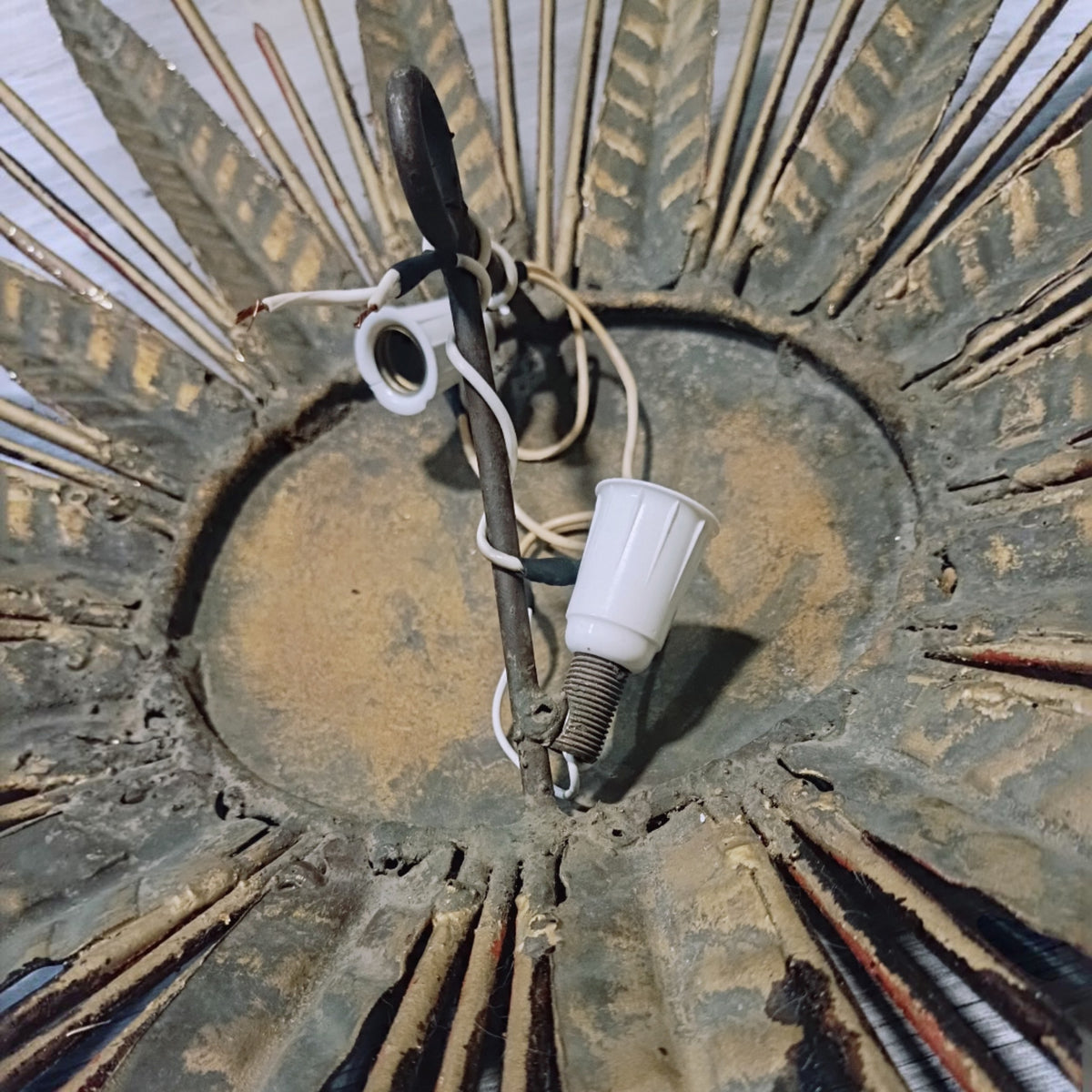 Close-up of a rear lamp holder and wiring against the aged metal back